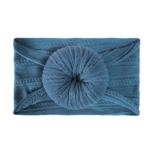 Detailed front view of a grey-blue cable knit baby headband with a large donut knot