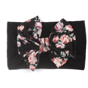 Détail du bandeau bébé élastique avec un grand nœud en nylon à motif de roses