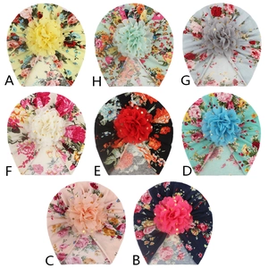 Collection of eight floral baby beanies in various colors with golden dot mesh flowers