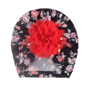 Floral baby turban hat with large red chiffon flower and gold sequins on black fabric