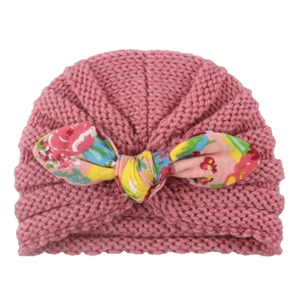 Infant knitted earflap beanie in dusty rose with a stylish floral print bow decoration