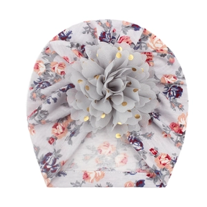 Detail of baby turban hat with gray floral print and 3D mesh flower with gold sequins