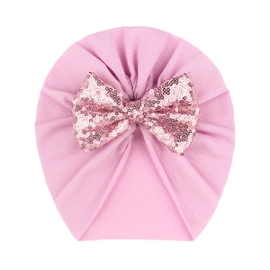 Soft pink baby turban hat with a large sparkling sequin bow for infants