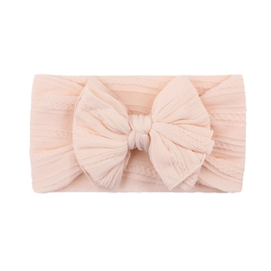Bandeau bébé en nylon jacquard doux avec grand nœud et texture tricotée rose pâle