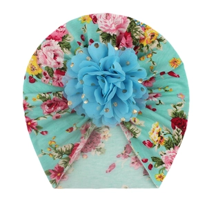 Floral print baby turban hat in mint green with a large 3D blue chiffon flower