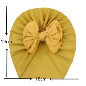 Soft yellow baby turban hat with large bow decoration and rib knit texture size 19x18cm