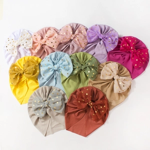 Ribbon knit baby turban hats with large gold foil polka dot bows in multiple colors
