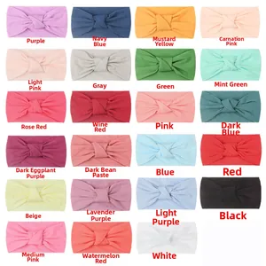 Macro view of 23 soft nylon baby headbands showing various colors and knotted textures