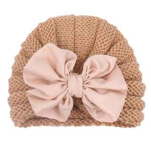 Close-up detail of the soft ribbed knit texture and decorative bow on infant beanie