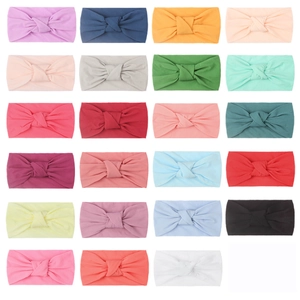 Soft nylon baby headbands set in 23 solid colors with classic knotted design for infants
