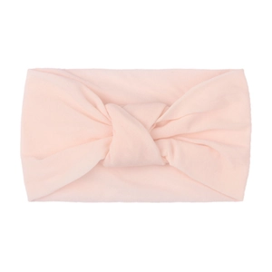 Detail view of pink soft nylon wide headband with double-layered knotted design for baby girls