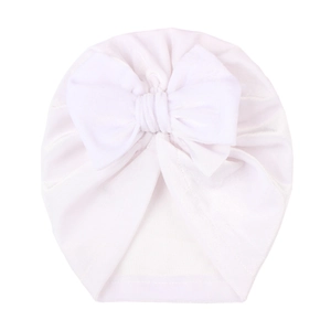 Close-up of pure white baby turban hat with a large bow detail and soft elastic fabric