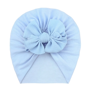 Detail of soft light blue baby turban hat with a large textured bubble gauze bow knot
