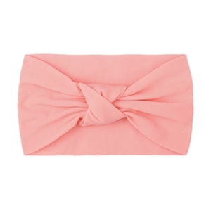 Detail of peach pink nylon knotted wide headband with soft elastic knit texture