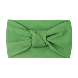 Close-up of grass green knotted nylon headband showing high elasticity and soft texture