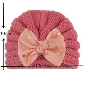 Size detail of pink baby knit hat with large sequin bow showing 14x16cm dimensions