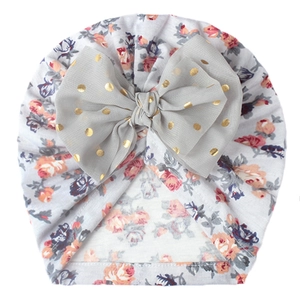 Soft cotton baby turban hat with floral rose print and large gold polka dot mesh bow