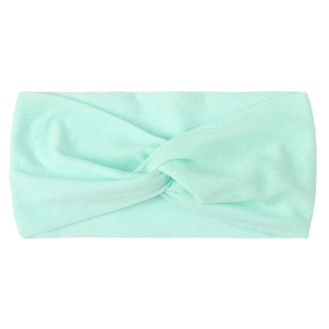 Detailed texture of a mint green knotted nylon hair band for babies and girls
