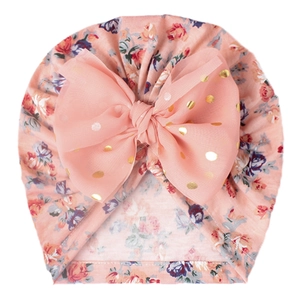 Pink floral infant turban hat with a large gold-dotted mesh bow for newborn baby girls