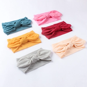 Detail showing set of six colorful soft nylon baby headbands with large bow knots