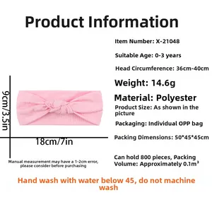 Pink ribbed baby headband with bow, showing detailed fabric texture and size specifications