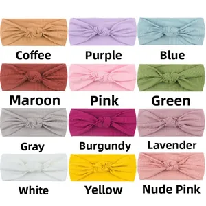 Detail showing 12 colors of ribbed knit knotted baby headbands in a neat grid layout