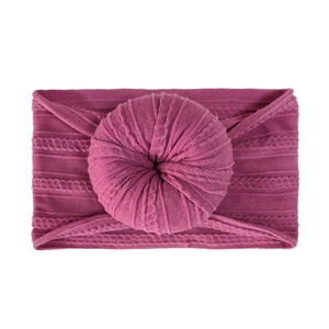 Soft nylon donut headband for babies in deep magenta purple with ribbed knit texture