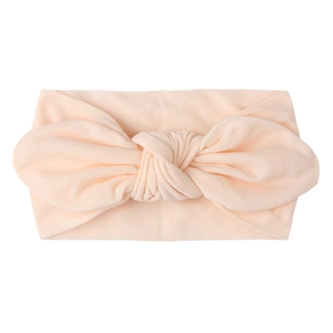 Peach baby wide elastic headband featuring a large soft decorative bow for girls