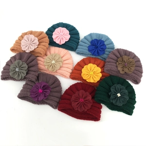 Assorted colors of baby knitted turban hats with large handmade fabric flowers