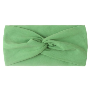 Detail of soft grass green nylon hair band with a stylish knotted cross design