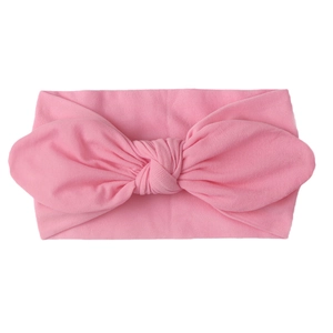 Close-up of pink soft nylon baby turban headband with large bunny ear bow detail
