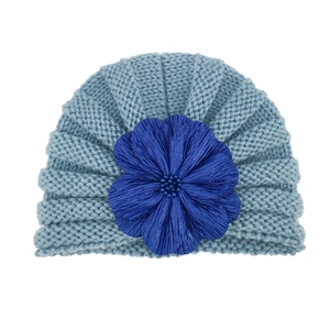 Detailed view of baby turban hat with light blue knit and navy blue fabric flower