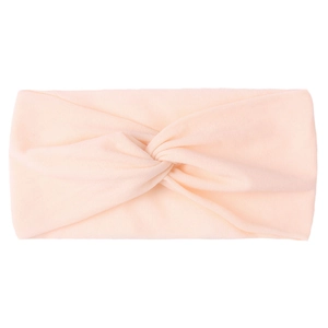 Detail of soft peach knotted nylon headband with tidy stitching for baby girls