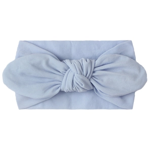 Detail of soft sky blue nylon baby turban headband with large bow knot on white background