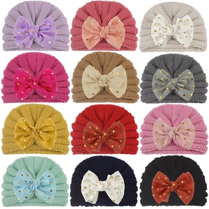 Knitted baby turban hats with chiffon gold polka dot bows in twelve solid colors