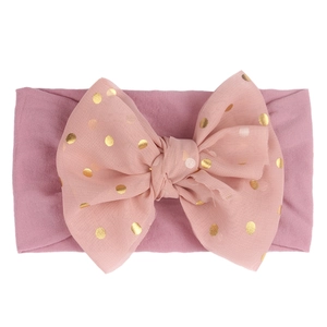 Bandeau bébé rose clair avec bande en nylon et nœud à pois pailletés dorés