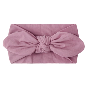 Diadema suave malva para bebé con un lazo grande y diseño de punto elástico ancho