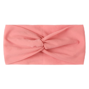 Detailed view of a soft pink knotted nylon hair band for babies on a clean white background