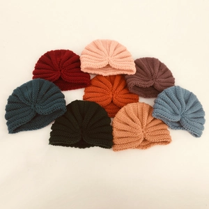 Set of eight assorted colorful knit baby turban hats with bohemian knot detail for warmth