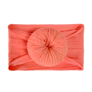 Soft nylon infant headband featuring a bright orange doughnut knot in stretchy knit fabric
