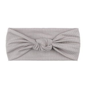 Close-up of light gray ribbed knit baby headband with a stylish knot detail in the center