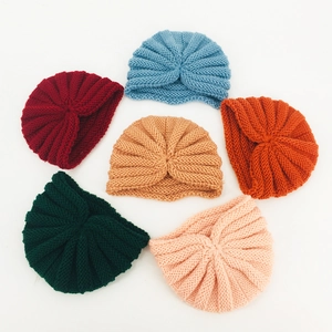 Set of six colorful knitted baby turban hats in burgundy, blue, pink, and more colors