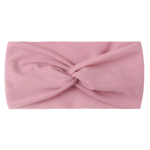 Close-up of pink twisted knot nylon hair band with soft elastic texture on white background