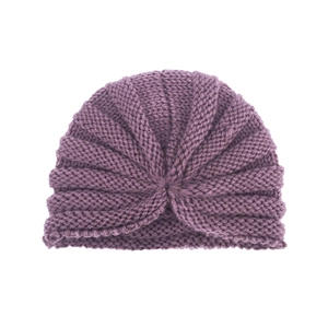 Detail of a purple knitted baby hat with a central knot design and ribbed texture