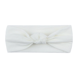 Close-up of white ribbed knit baby headband featuring a decorative center knot detail
