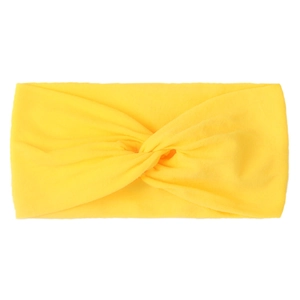 Detail of a bright yellow twisted knot nylon baby headband with soft knit fabric texture