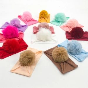 Elastic nylon baby headbands with large soft pom-poms in a multi-color ring layout