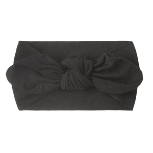 Close-up of a soft black nylon headband for babies featuring a knotted bunny ear bow
