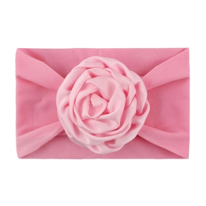 Soft pink nylon baby headband featuring a handcrafted satin rosette flower accessory