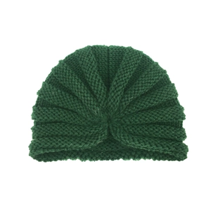 Detailed view of dark green knitted turban hat with ribbed texture and twisted knot detail